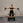 Woman exercising with Pilates reformer against a brick wall.