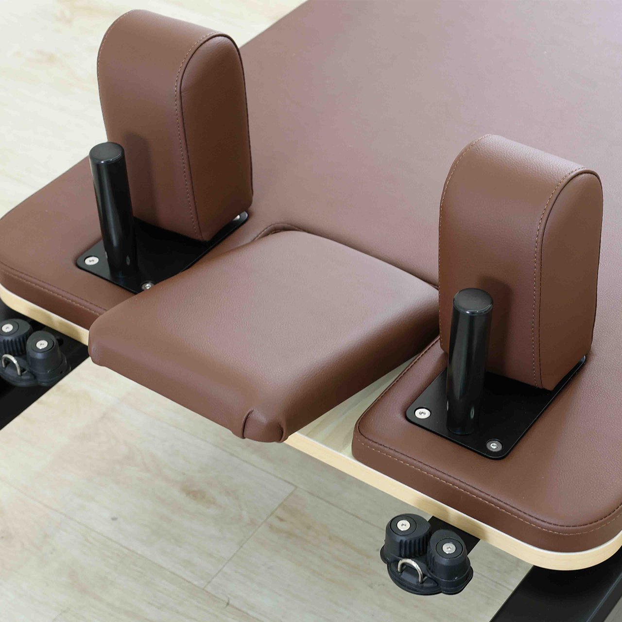 Brown leather material on a pilates reformer machine.