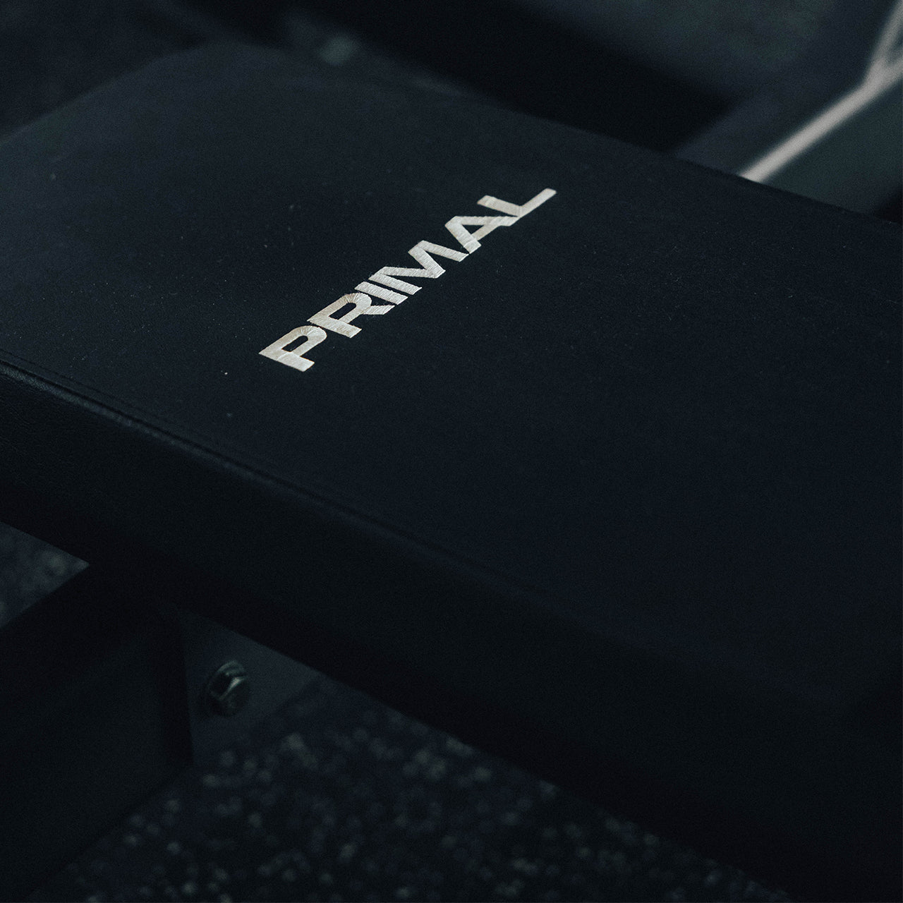 Stitched Primal branding on a pad of a weight bench.