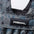 Close-up of a Primal brand label on a camouflage-patterned weighted vest.