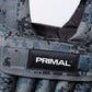 Close-up of a Primal brand label on a camouflage-patterned weighted vest.
