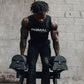 An athlete lifting a pair of 40kg adjustable dumbbells from a stand.