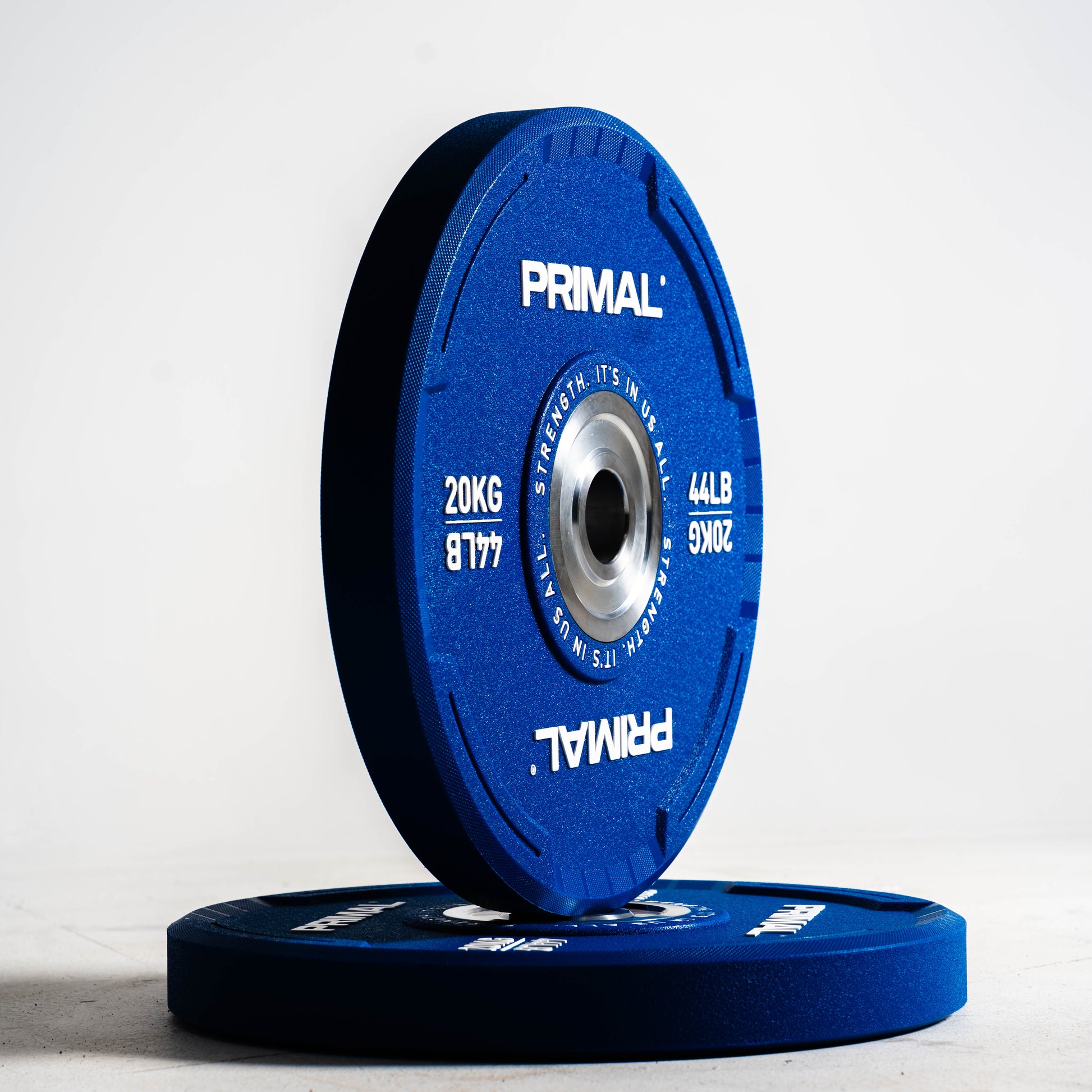 Blue Primal weight plate on a white background