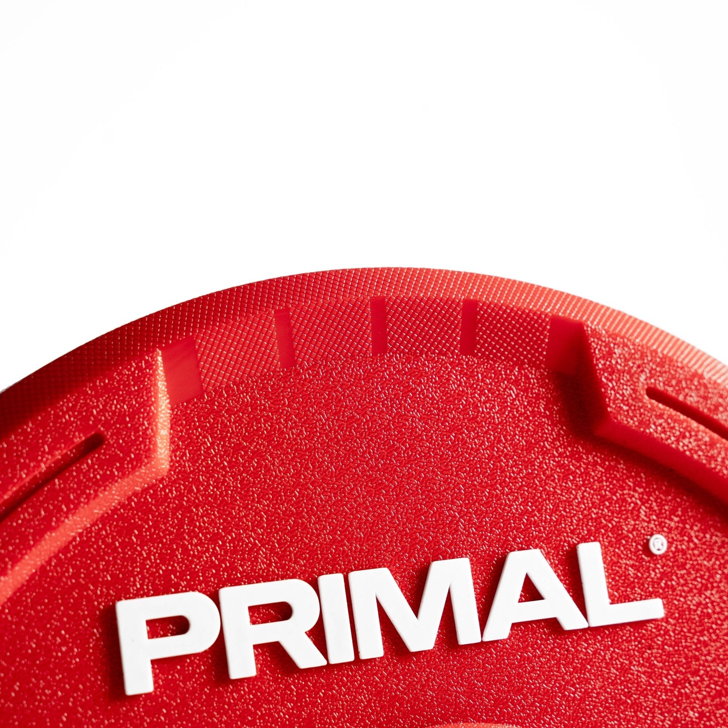 Red urethane bumper plate with Primal branding and contoured grip handle
