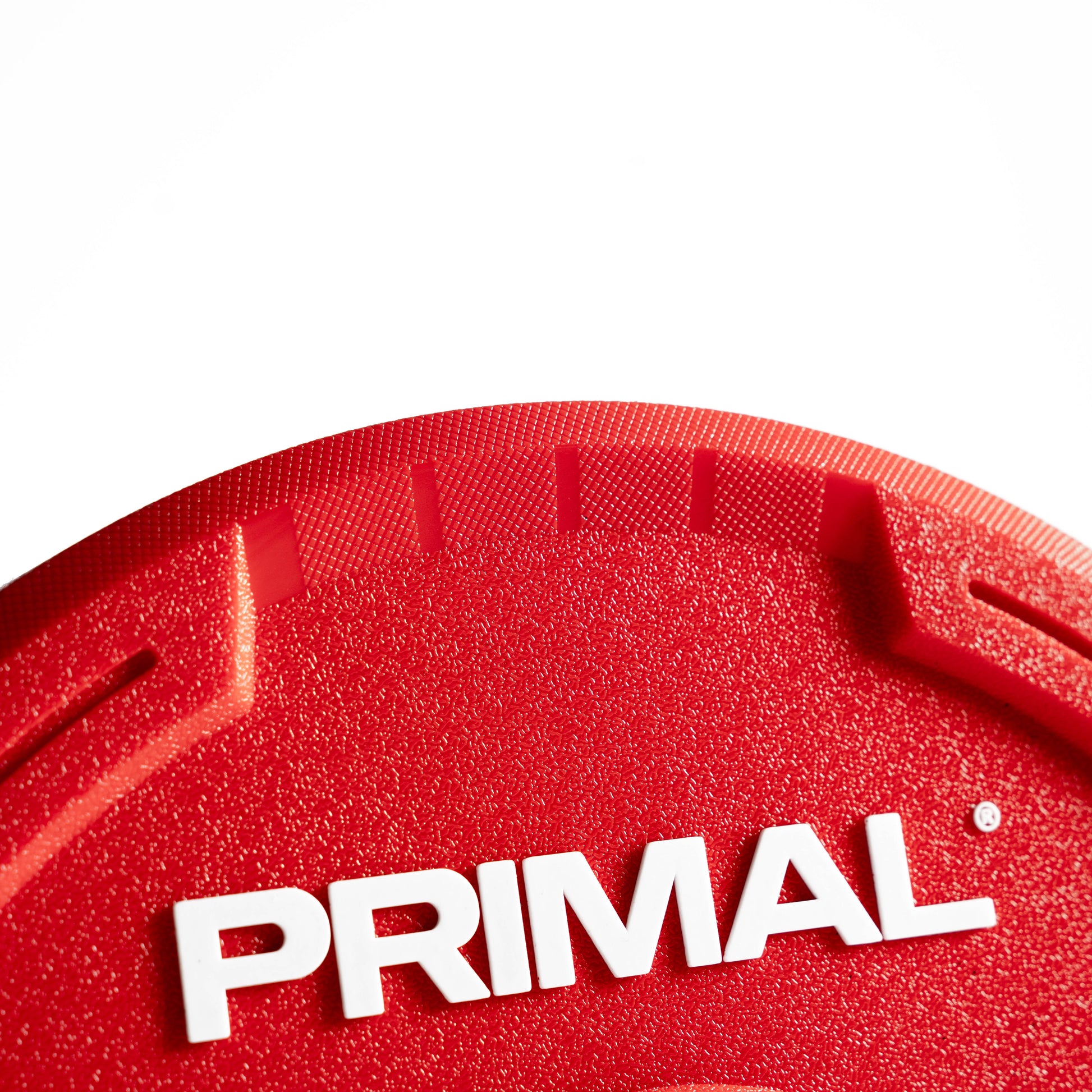 Red urethane bumper plate with Primal branding and contoured grip handle