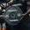 Person holding a Primal Strength weight plate in a gym setting