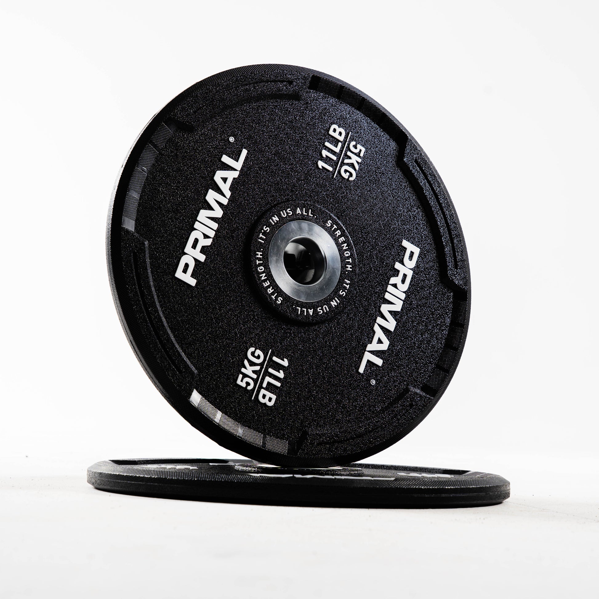 Two Primal bumper plates on a white background