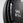 Close-up of a black weight plate with '5KG' and '11LB' text on a gray background