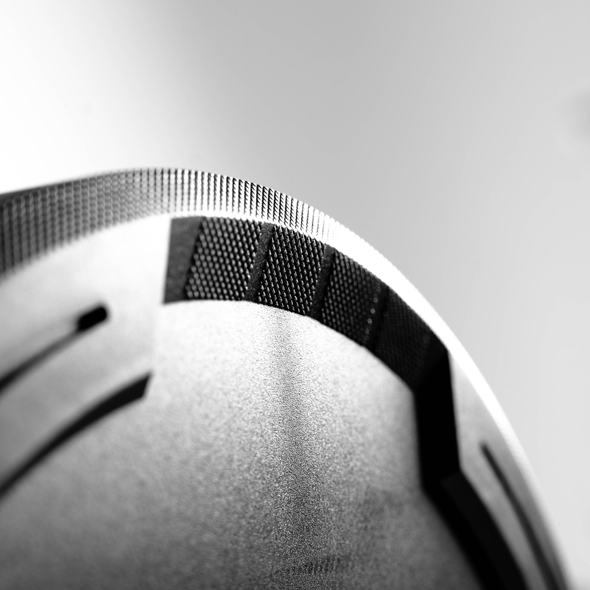 The contoured grip handle on a black rubber bumper plate