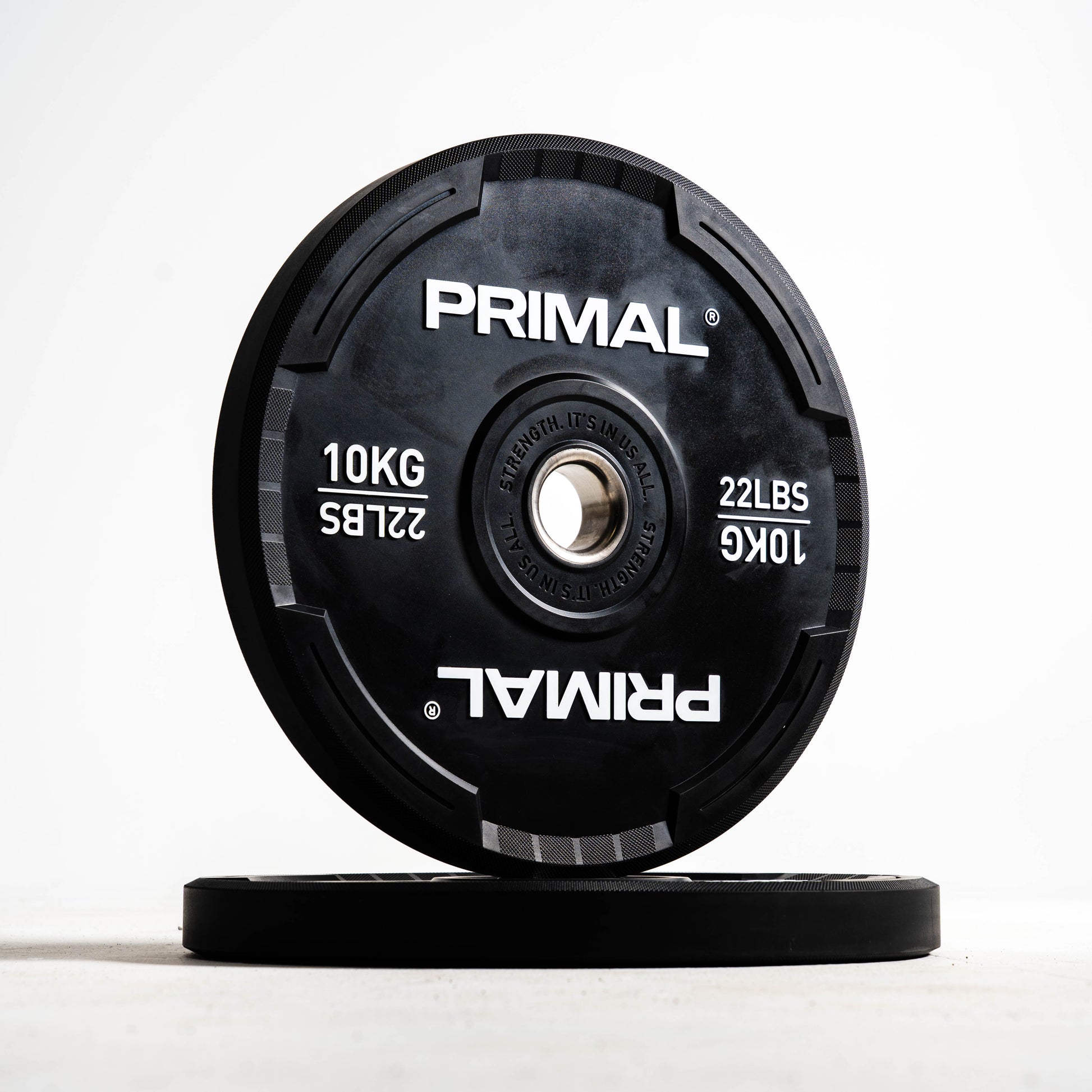 Two Primal branded weight plates on a white background