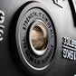 Close-up of a weight plate with motivational text and weight measurement.