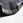 Close-up of a Grey & black bumper plate with a textured pattern on a light gray background