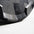 Close-up of a Grey & black bumper plate with a textured pattern on a light gray background