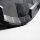 Close-up of a Grey & black bumper plate with a textured pattern on a light gray background