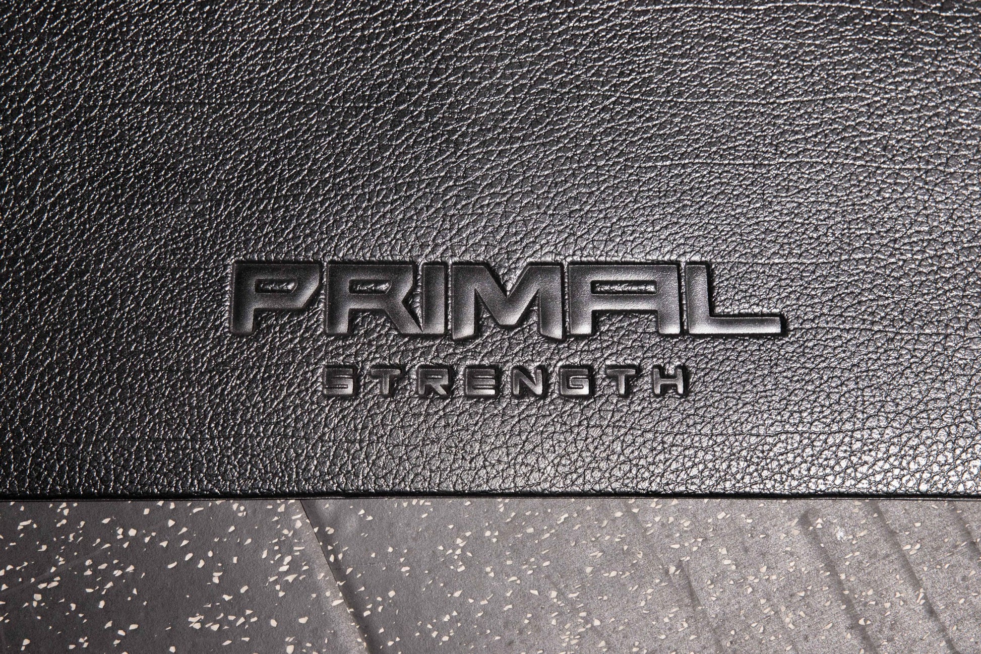 the embossed primal strength logo on a fitness mat