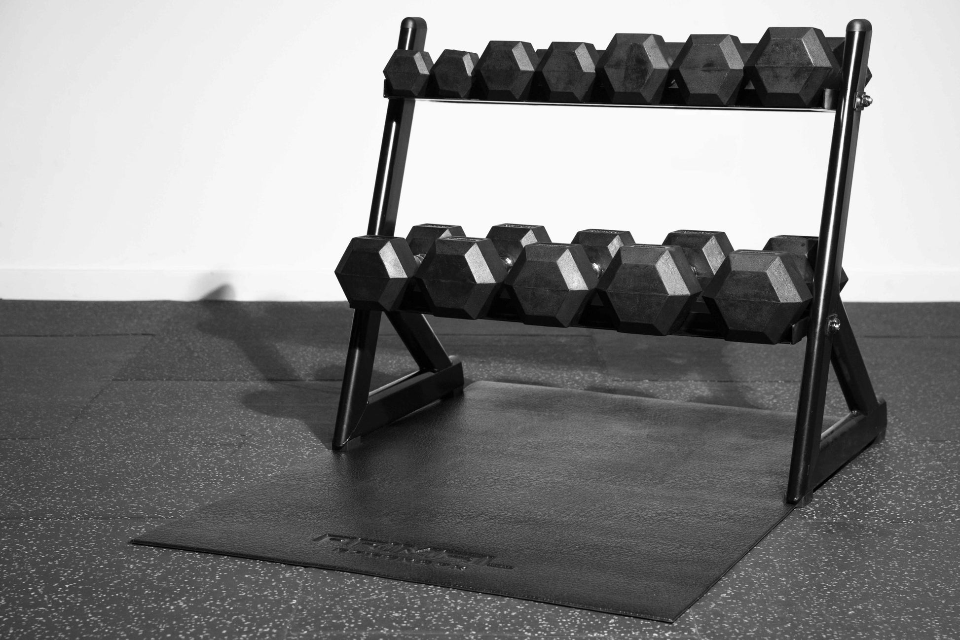 a full 2 tier small dumbbell rack on a black fitness mat