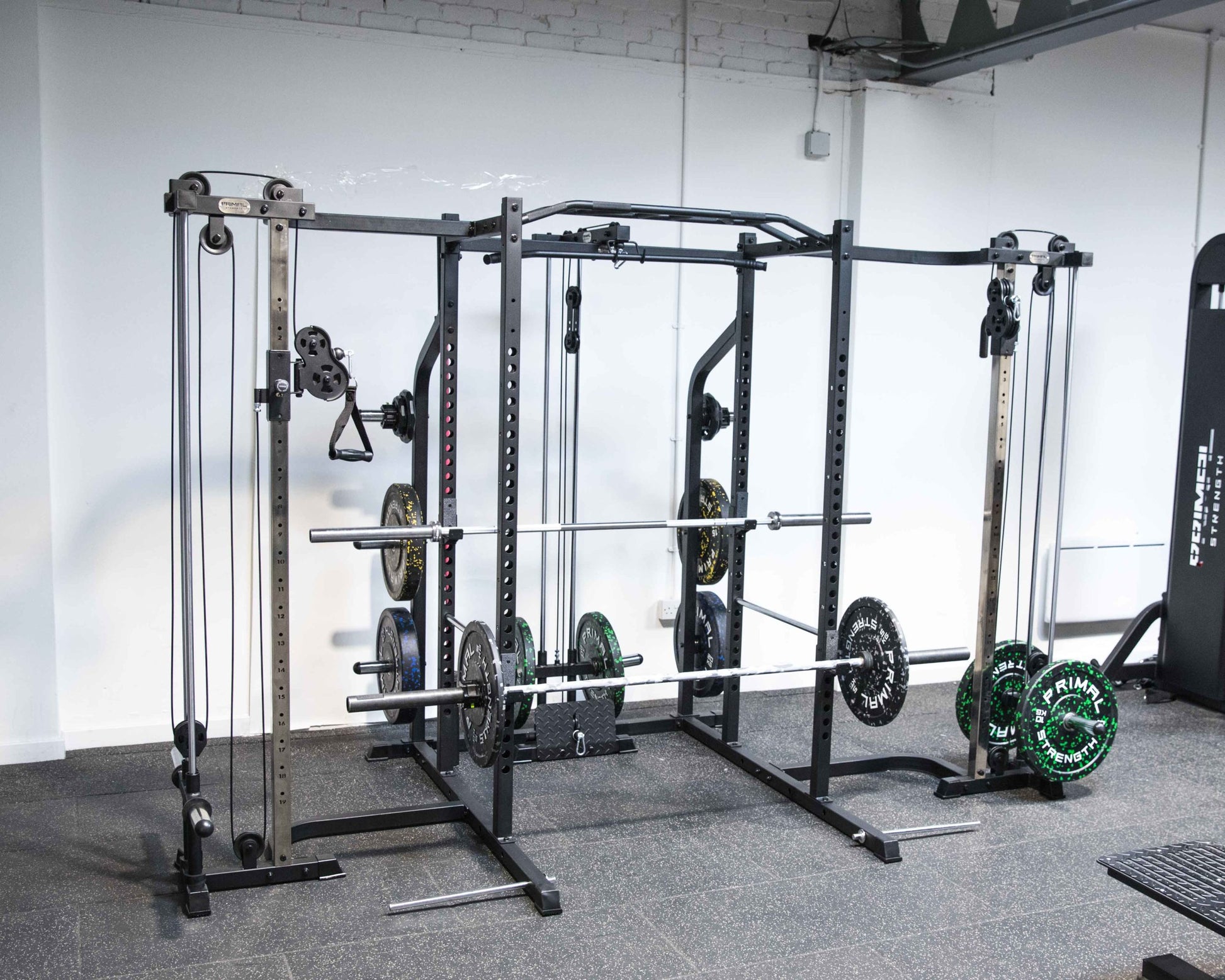 a rack mounted cable crossover attached to a power rack in a gym