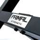 a metal plate with a lasered primal strength logo on a preacher curl bench