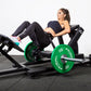 a woman performing hip thrusts on a plate loaded glute drive gym machine