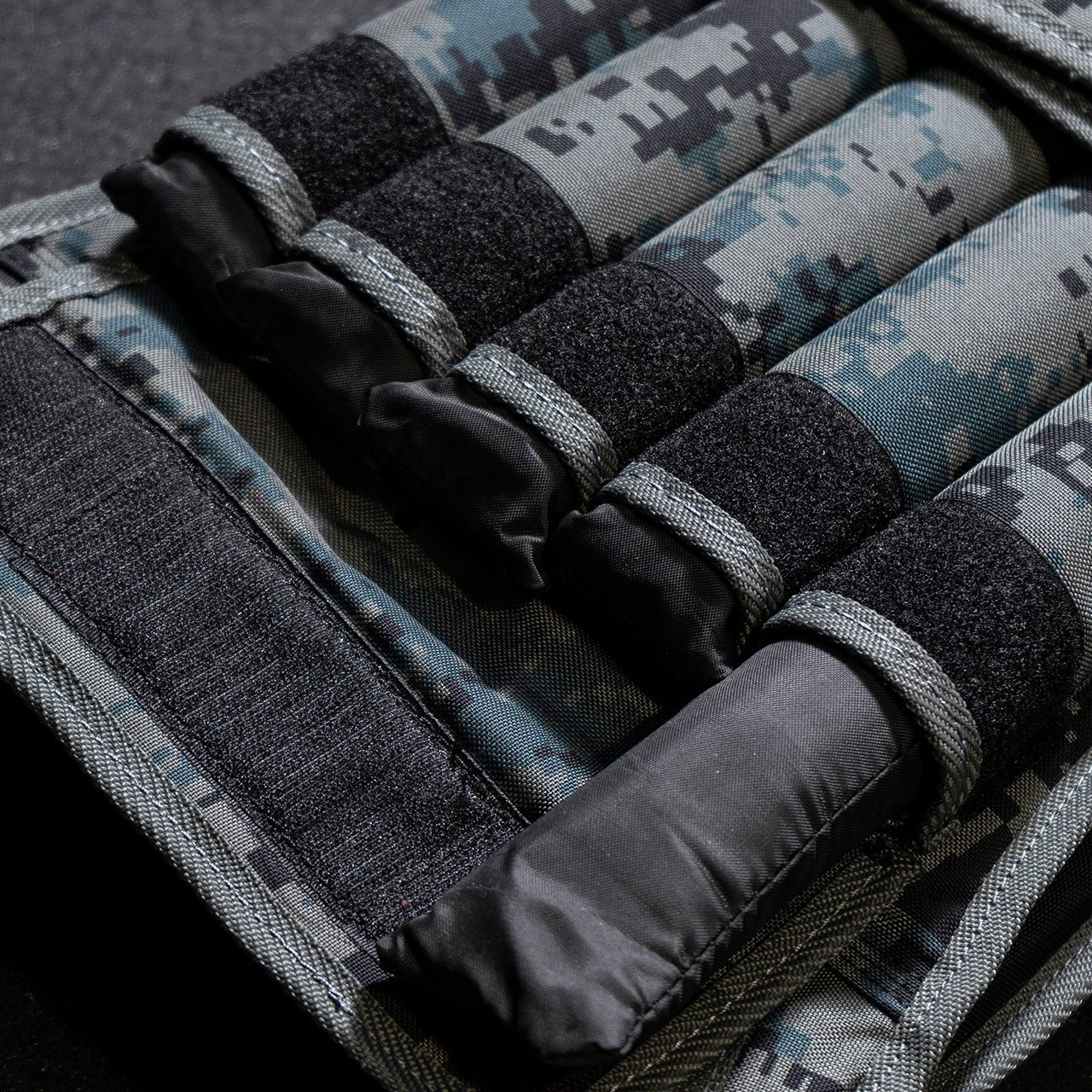 Close up the 2kg weight packs stored inside a 20kg camouflage weighted vest.