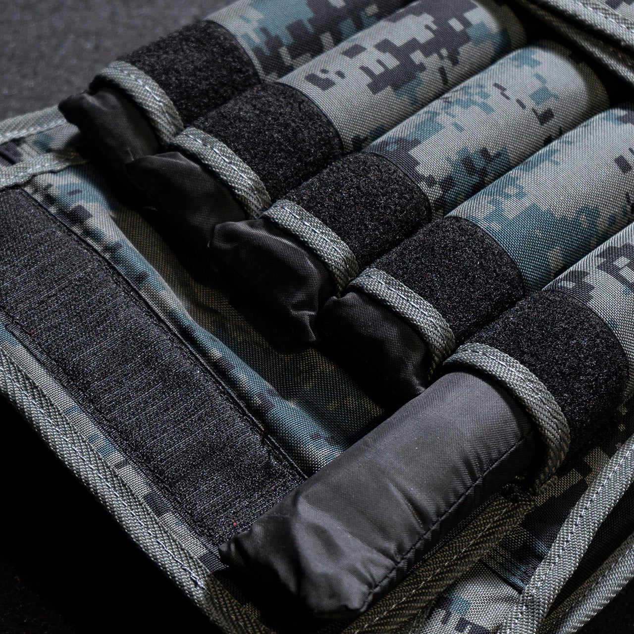 Close up the 2kg weight packs stored inside a 20kg camouflage weighted vest.