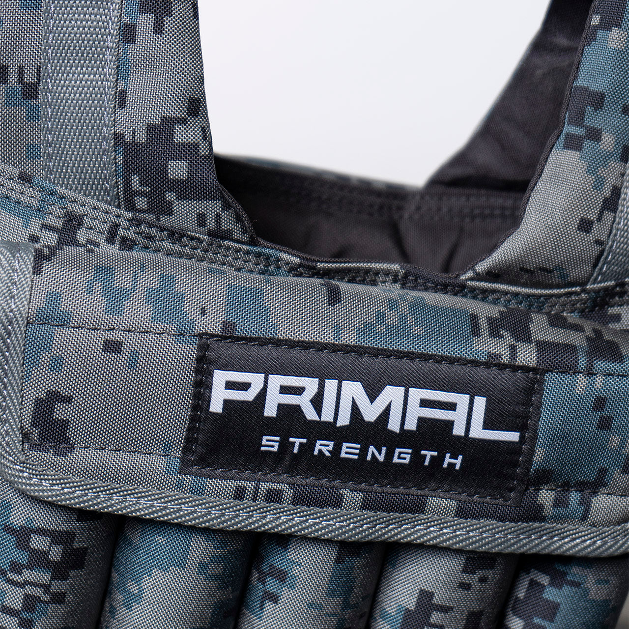 A close up of the Primal branding on a 20kg camouflage weighted vest.
