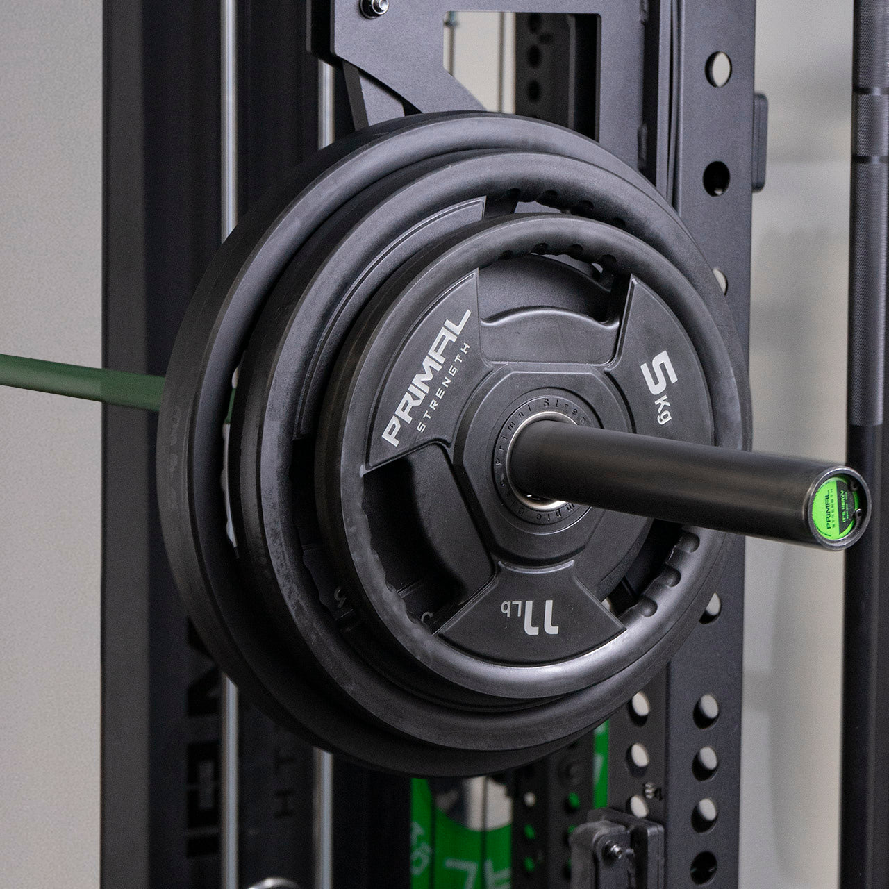 A set of black olympic weight discs on a steel barbell.