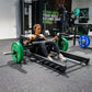 a woman performing hip thrusts with a hip thrust barbell and floor hip thrust bench