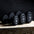 three single primal strength black urethane dumbbells on a wooden box