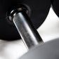 the stainless steel handle of a black urethane dumbbell