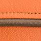 orange leather with brown stitching