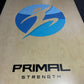 a custom olympic lifting platform with the primal strength logo