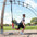 a man performing bulgarian split squats with a suspension trainer in a park