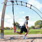 a man performing bulgarian split squats with a suspension trainer in a park