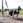 a man performing ab exercises with a suspension trainer in a park