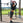 a woman exercising with a suspension trainer in a park