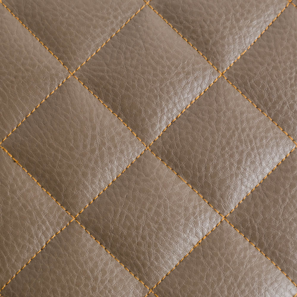 a custom orange stitching pattern on brown leather