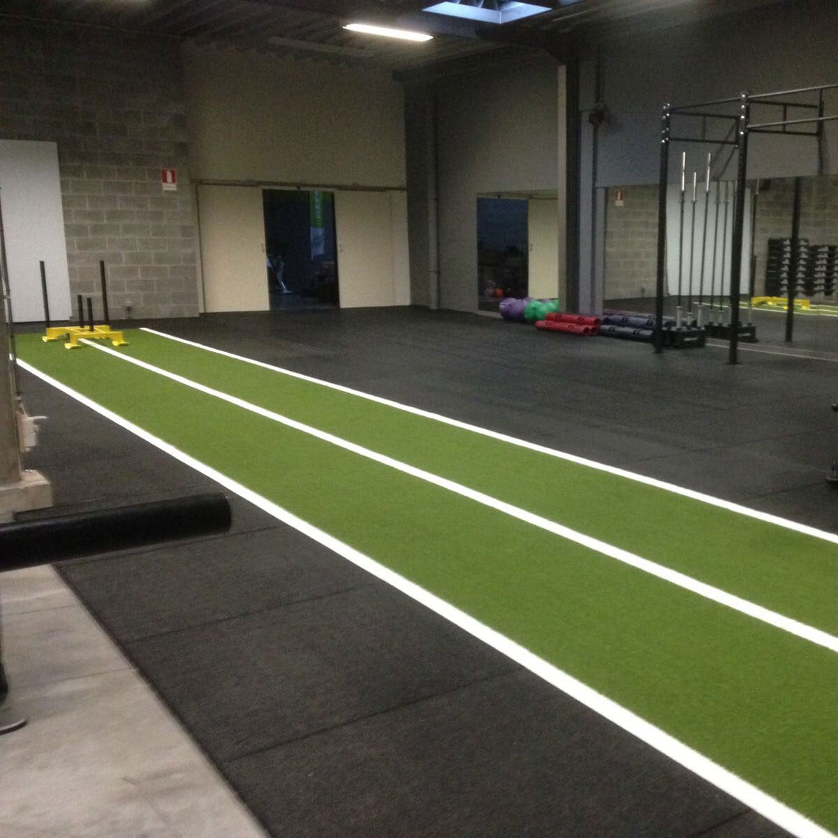 a green gym astroturf track in a gym