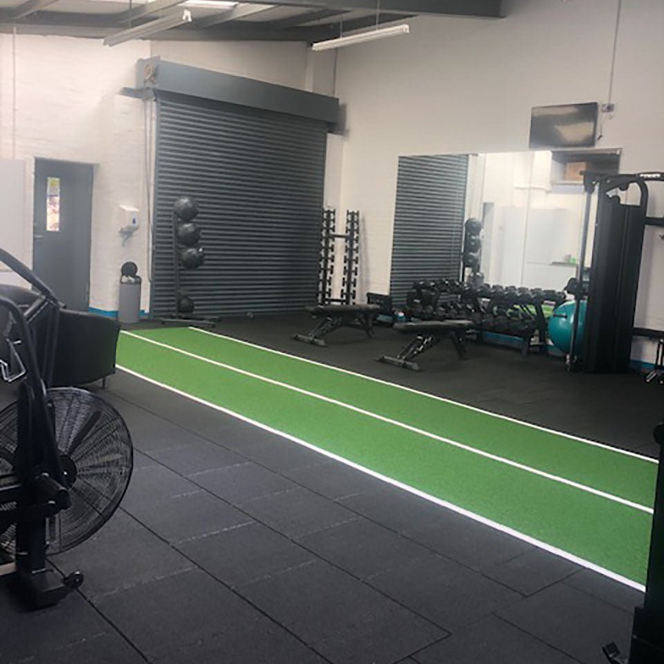 a green gym astroturf track in a gym