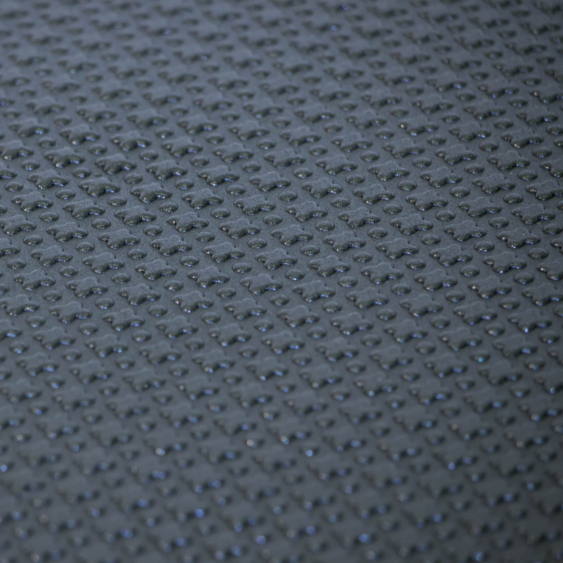 the textured surface of a black fitness exercise mat