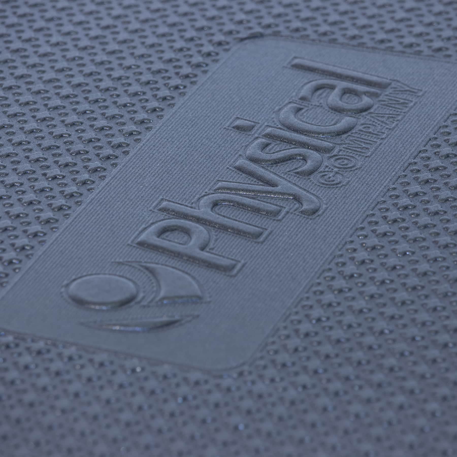 physical company embossed logo on a black fitness exercise mat